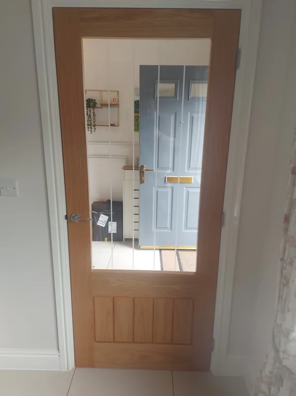 Glazed oak door fitted between two rooms